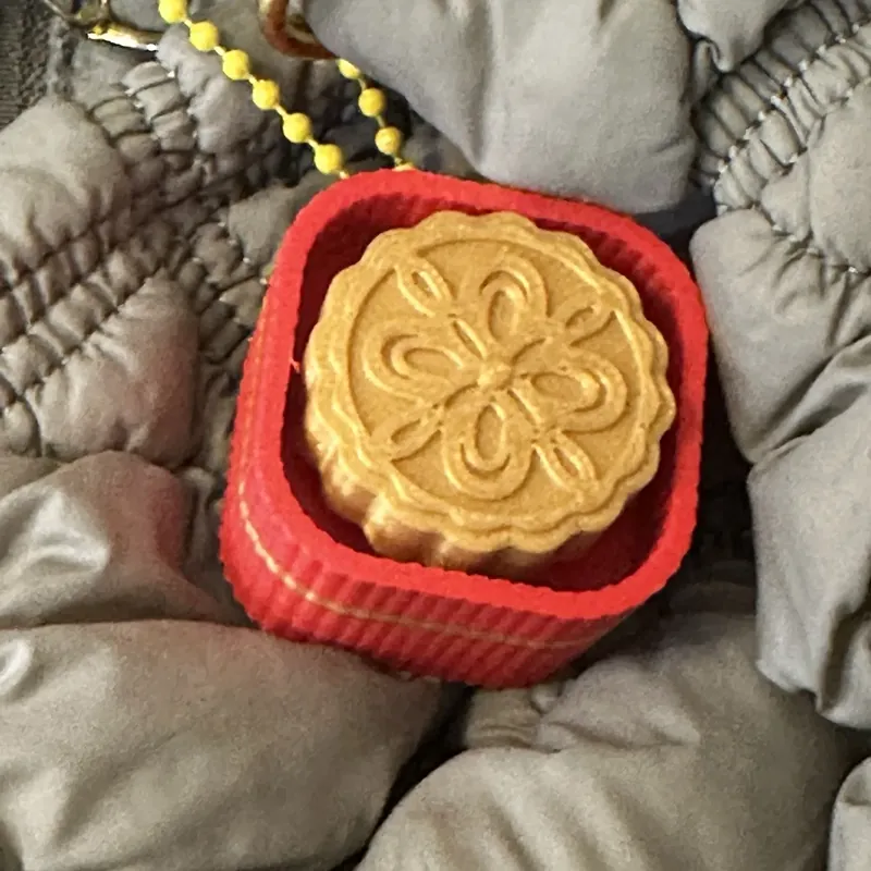 @eileen.ph's print of the Mooncake clicker: a gold mooncake in a red base